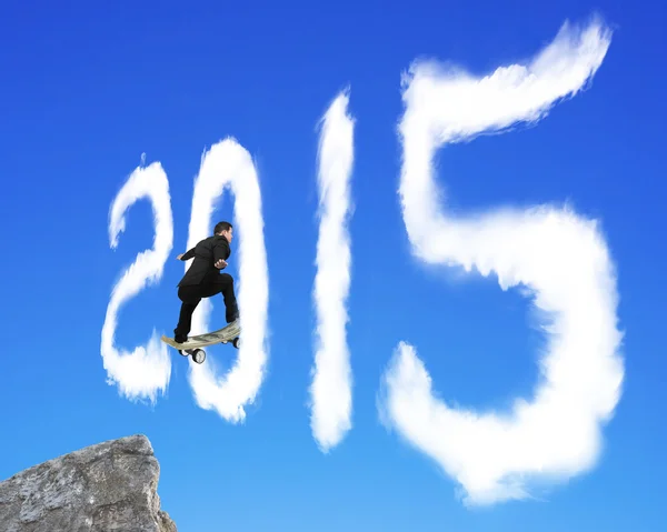 Skateboarding businessman passing through 2015 shape cloud on bl — Stok fotoğraf