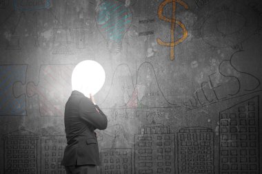 Thinking businessman with lamp head illuminated dark business do