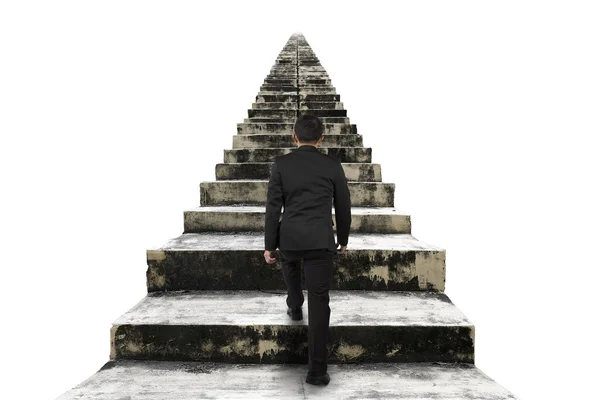 Businessman climbing the old concrete stairs isolated on white — 스톡 사진