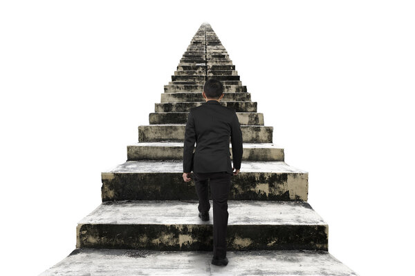 Businessman climbing the old concrete stairs isolated on white