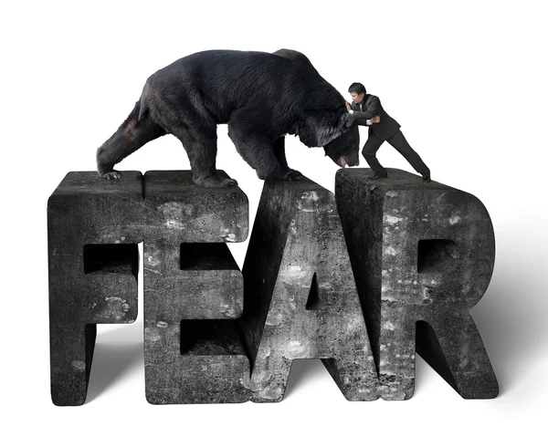 Empresário lutando contra urso preto em 3d medo palavra concreta — Fotografia de Stock