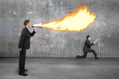 Angry boss using megaphone yelling to employee and spitting fire
