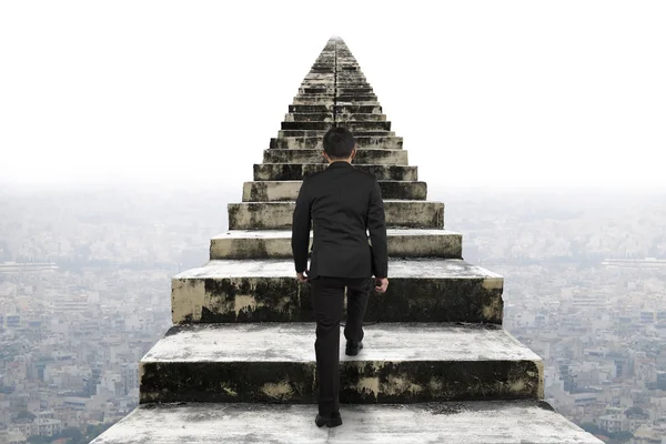 Businessman climbing the old concrete stairs with urban scene