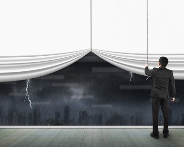 Man pulling open blank white curtain heavy rain dark cityscape