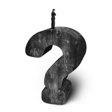 Businessman standing on huge 3D concrete question mark white bac