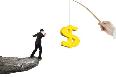 Man balancing golden dollar sign fishing lure isolated on white