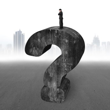 Businessman standing on huge 3D concrete question mark cityscape