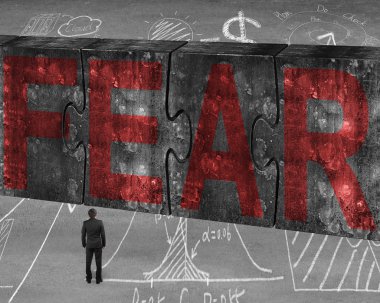 Businessman facing red fear word on huge concrete puzzles connec