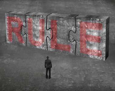 Businessman facing red rule word on huge concrete puzzles connec
