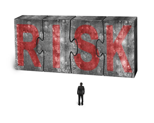 Man facing red risk word on huge concrete puzzles connected — Stockfoto