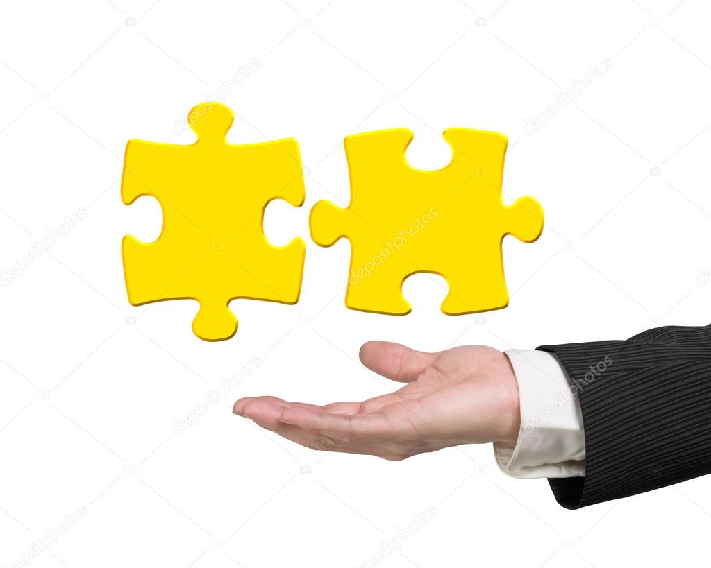 Man hand showing two 3D gold jigsaw puzzle pieces