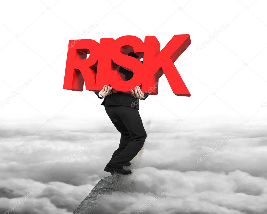 Man carrying red RISK word on ridge with cloudscape cityscape