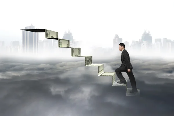 Man climbing on money stairs with cityscape cloudscape — Stok fotoğraf