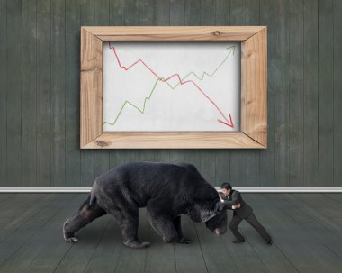 Businessman fighting against bear with trend lines whiteboard