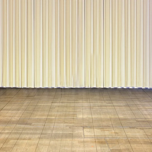 Indoor stage with old wood floor and beige curtain — Stock Photo, Image