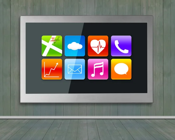 Black wide TV screen with app icons hanging on wall — Stock Fotó