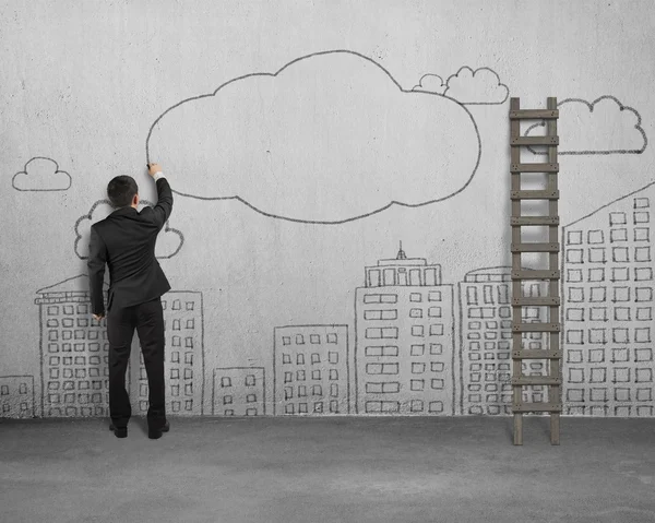 Businessman drawing clouds with copy space on concrete wall