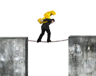 Businessman carrying golden dollar sign balancing on rusty chain