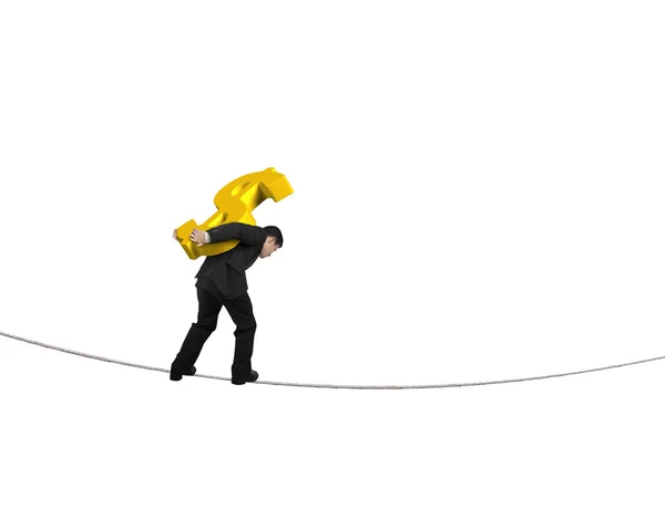 Businessman carrying golden dollar sign balancing on tightrope — Stock Photo, Image