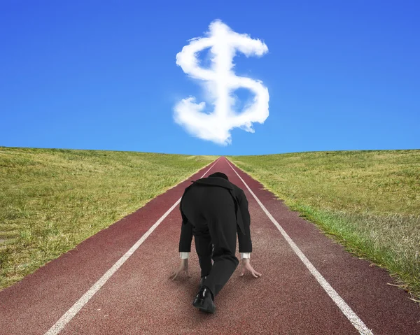 Businessman ready to race on running track toward dollar sign — Stock Photo, Image