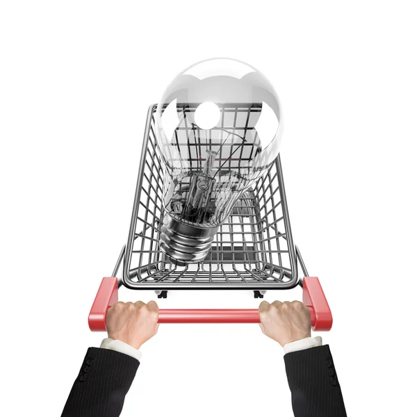 Hands pushing shopping cart with large light bulb — Stock Photo, Image