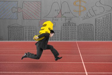 Businessman carrying golden euro sign running on track
