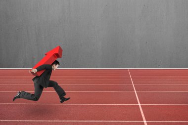 Businessman carrying red arrow up running on track