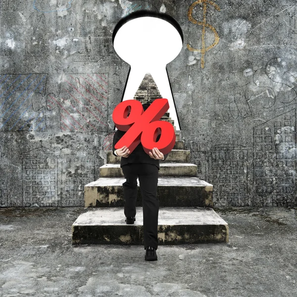 Man carrying percentage sign climbing old concrete stairs toward — Stock fotografie