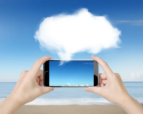 Woman hands holding smart phone with white cloud — Stock fotografie