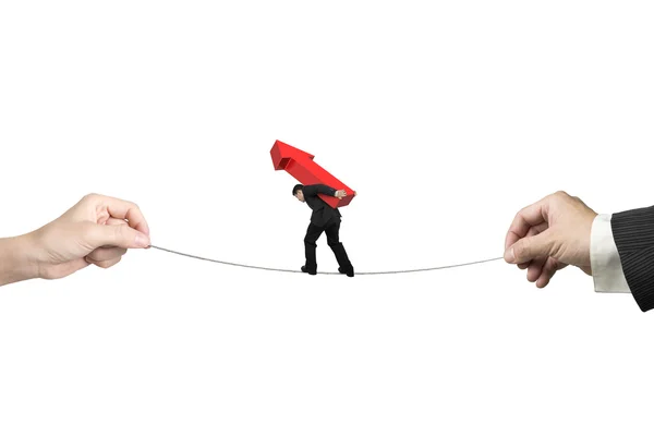 Businessman carrying arrow sign balancing tightrope with hands h — Stock Photo, Image