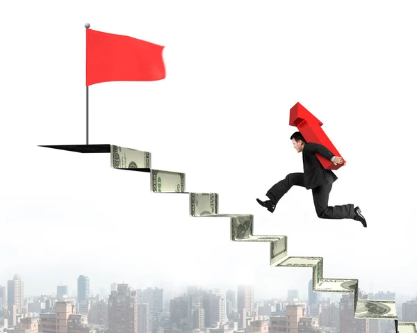 Businessman running on money stairs with arrow for top flag — Stock Photo, Image