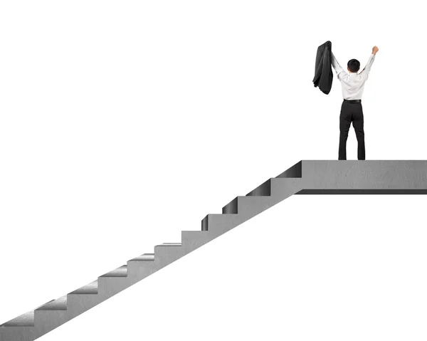 Businessman cheering on top of concrete stairs isolated in white — Stock Photo, Image