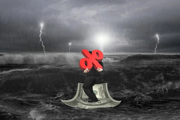 Businessman carrying 3D percentage symbol on money boat with sto — Stock Photo, Image
