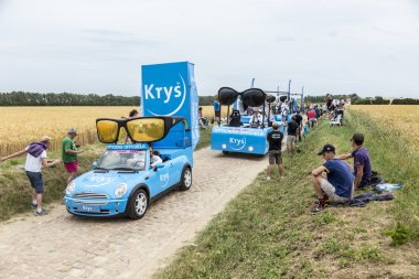Krys Caravan on a Cobblestone Road- Tour de France 2015 clipart