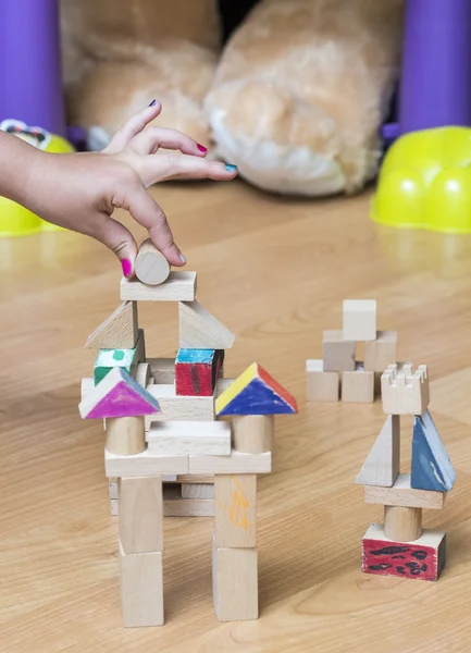 Little girl's hand building something — Stock Photo, Image