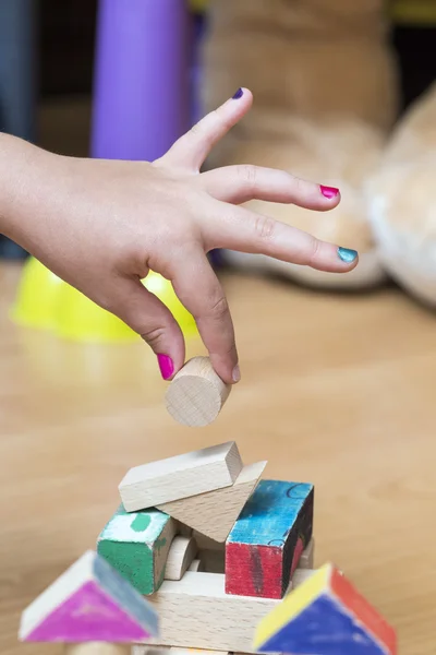 Little girl's hand building something — Stock Photo, Image