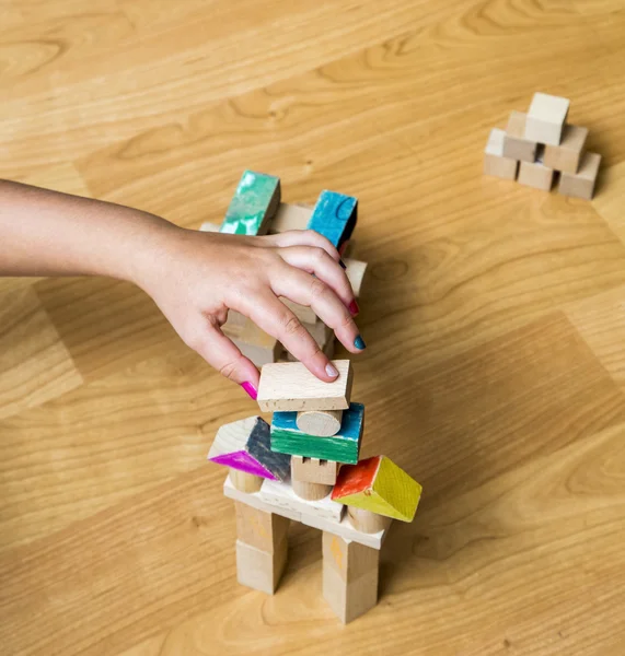 Little girl's hand building something — Stock Photo, Image