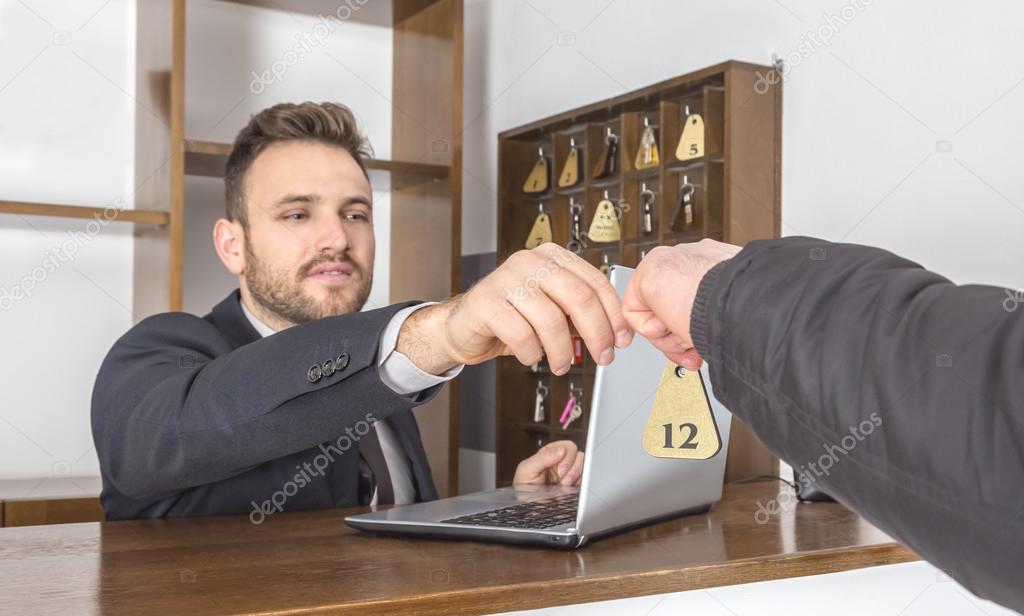 receptionist giving the key to a client