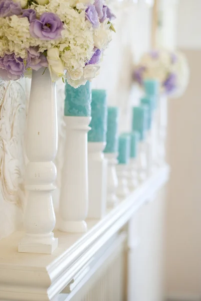 插花与白色和蓝色的花朵和烛台上的蜡烛 — 图库照片