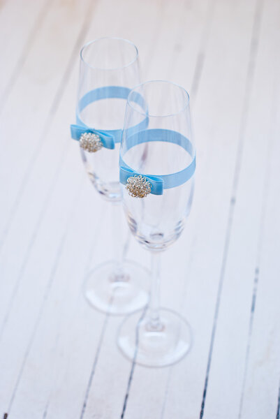 Two elegant champagne glasses with decoration ribbon.