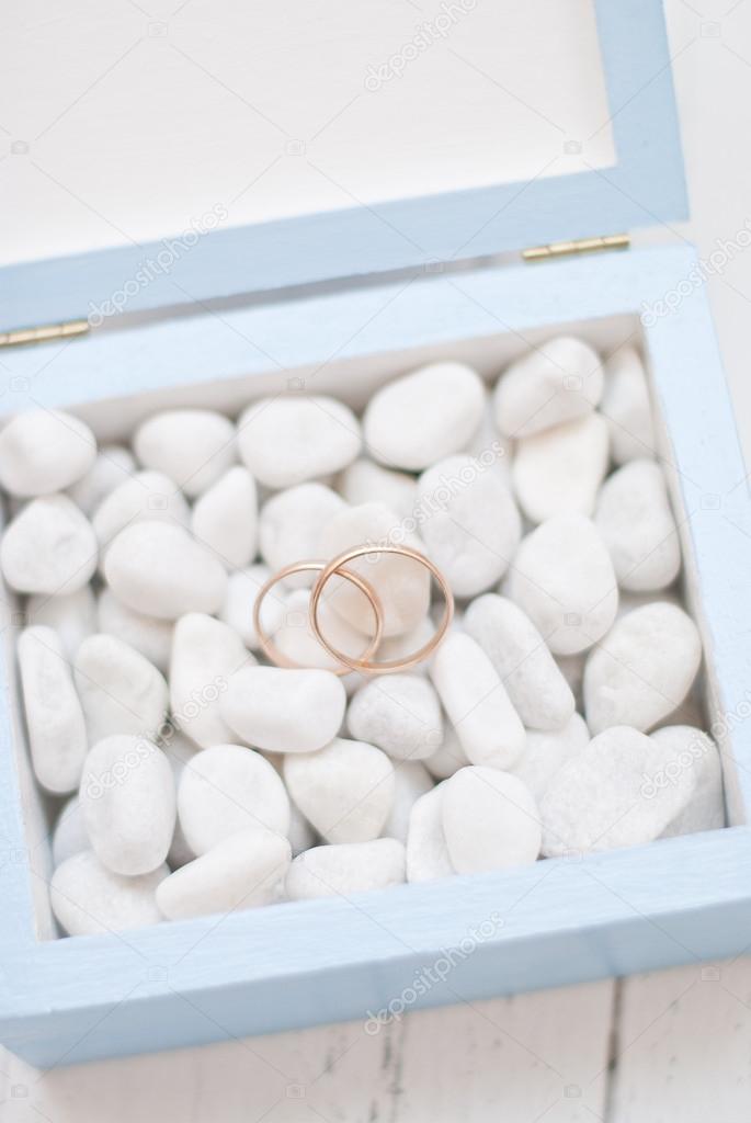 Wedding rings in blue box with white stone.Wedding ceremony