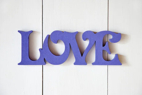 Dřevěné pozadí slovem láska — Stock fotografie