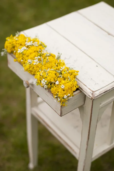 Vintage table with flowers in coffer — Stock Photo, Image