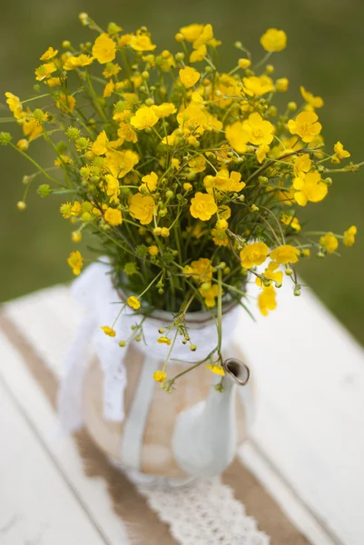 Yellow flowers in teapot — Stock Photo, Image