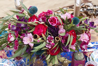 Fas stile çölde kum içinde masa aranjmanı düğün