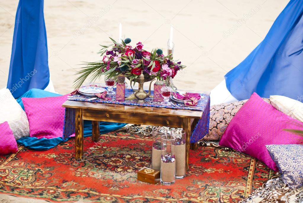 Wedding table arrangement in desert sand of Morocco stile