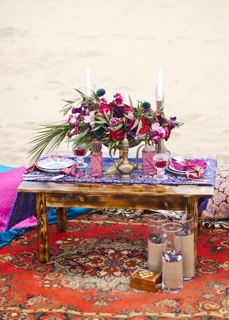 Wedding table arrangement in desert sand of Morocco stile