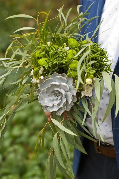 Beautiful wedding bouquet in hands of the groom — Stock Photo, Image