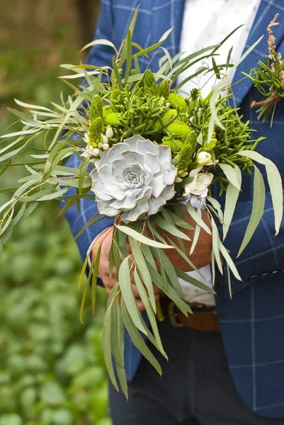 Beautiful wedding bouquet in hands of the groom — Stock Photo, Image