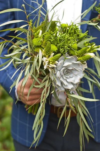 Beautiful wedding bouquet in hands of the groom — Stock Photo, Image